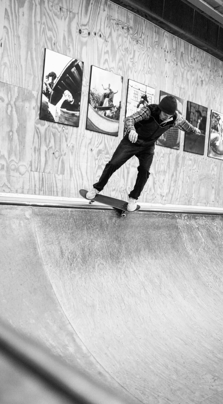 A skateboarder in a ramp doing a feeble